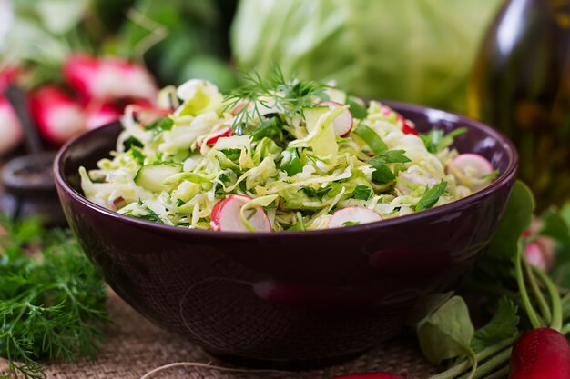 Vitamin salad of young vegetables: cabbage, radish, cucumber and fresh herbs