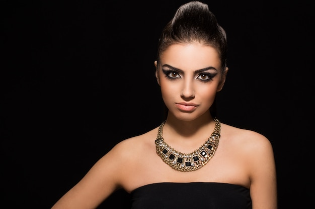 Vogue. Beautiful woman posing in black dress