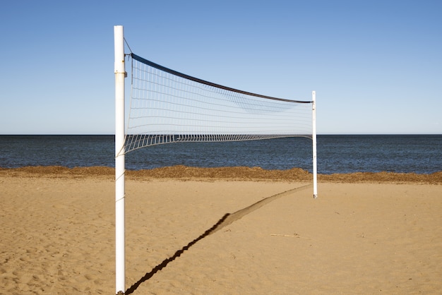 Volleyball net in the sandy beach during the daytime