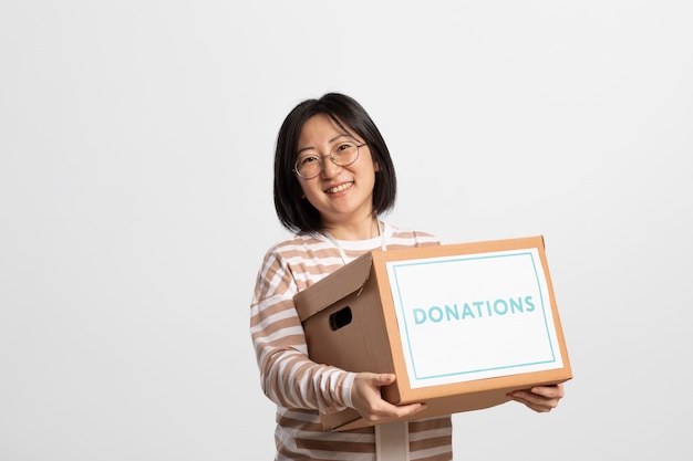 Free photo volunteer holding a box containing donations for charity