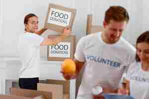 Free photo volunteers helping with food donations for charity day