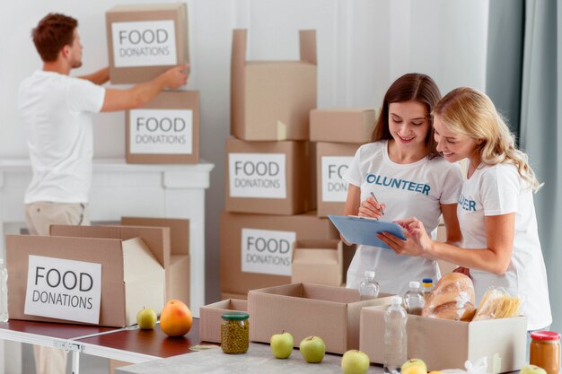 Volunteers preparing boxes with food for charity