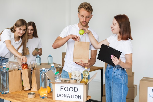 Free photo volunteers preparing boxes with food for donation