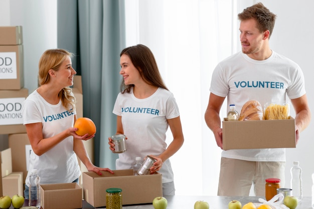 Volunteers preparing boxes with provisions for charity