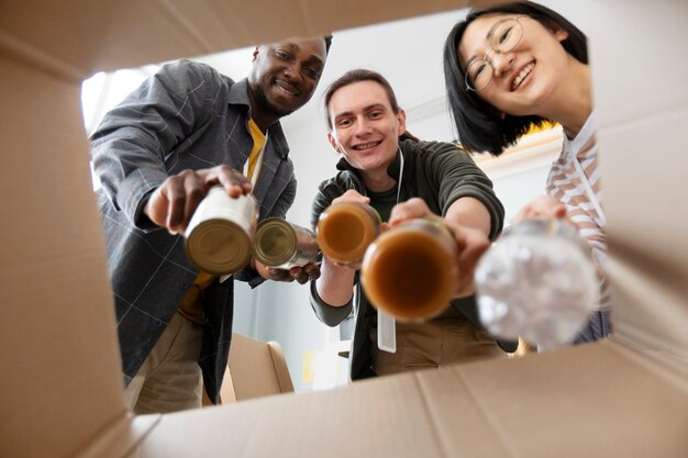 Volunteers putting food in box for charity donation