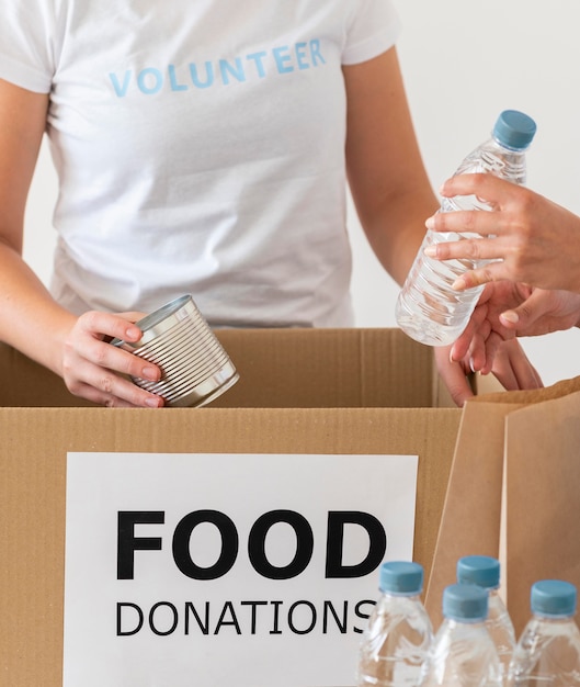 Volunteers with box and water for donation