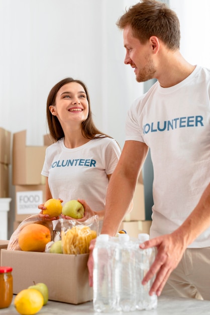 Free photo volunteers at work preparing food donations