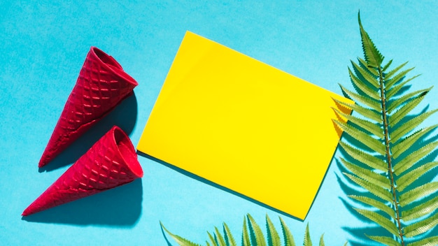 Free Photo waffle cones and sheet of paper on light background