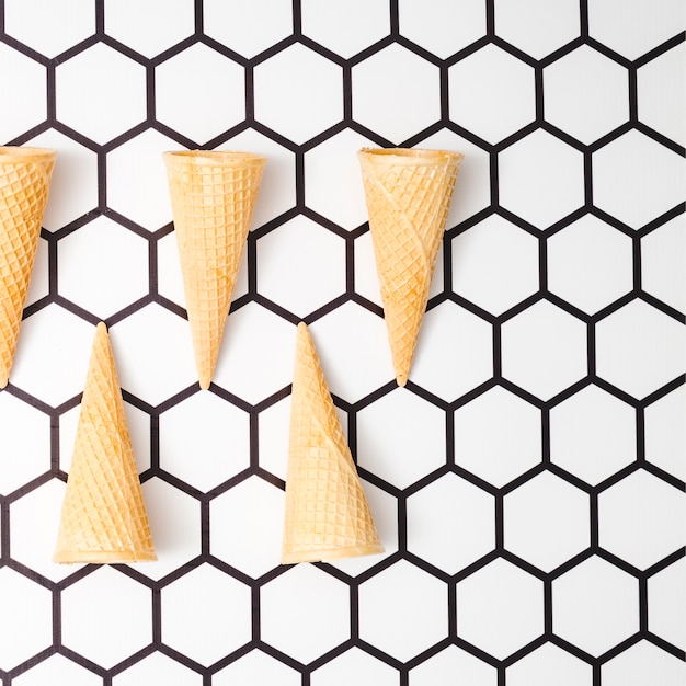 Waffle ice cream cones on hexagon background