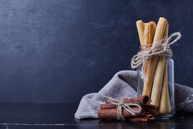 Waffle sticks and cinnamons in blue surface. 