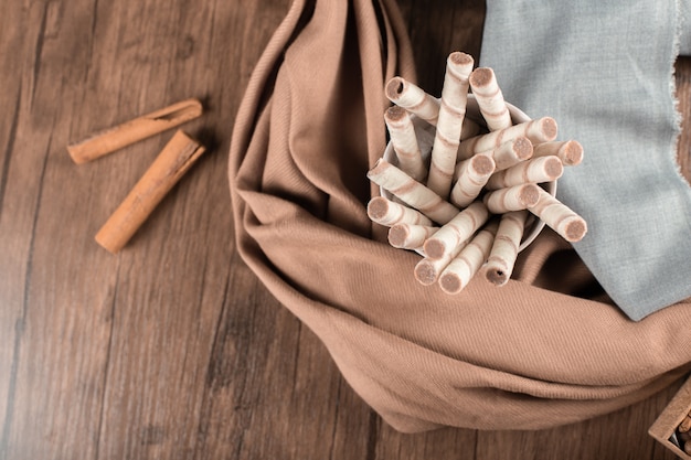 Waffle sticks and cinnamons on a wooden table