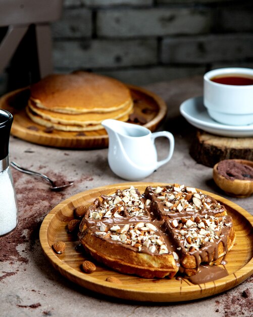 Waffle with chocolate sauce and almond pieces