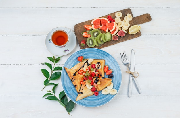 Waffles and fruits in blue plate with fruits