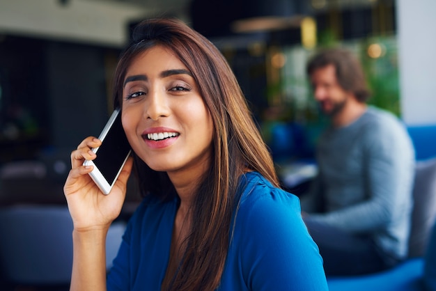 Waist up of Asian woman on the phone