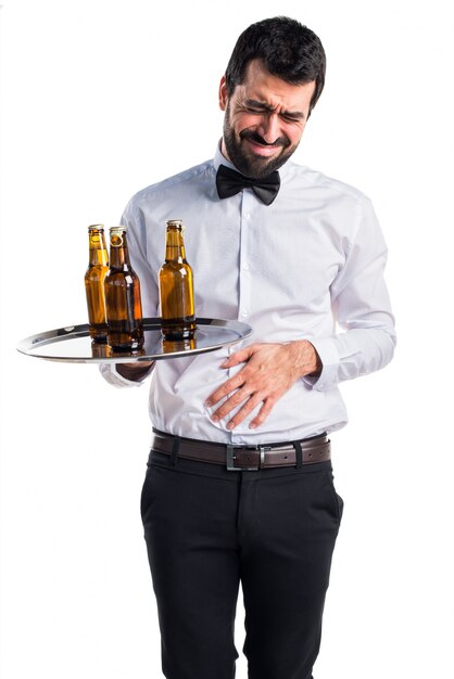 Waiter with beer bottles on the tray with stomachache