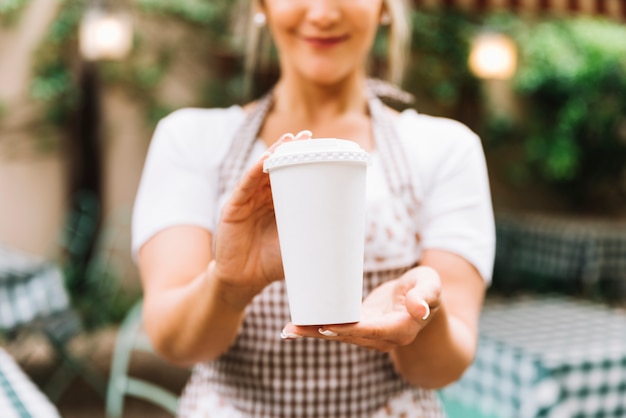 Waitress giving take away coffee