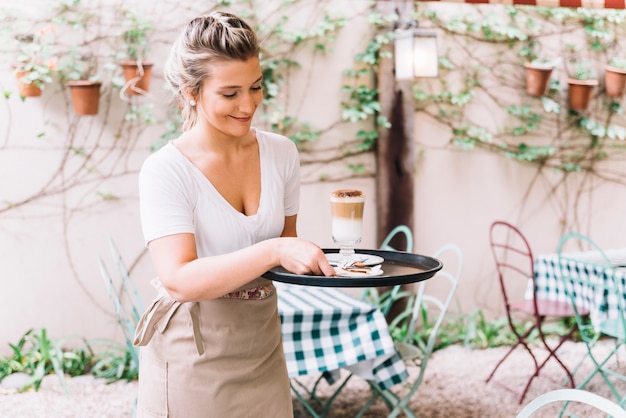 Free photo waitress serving coffee