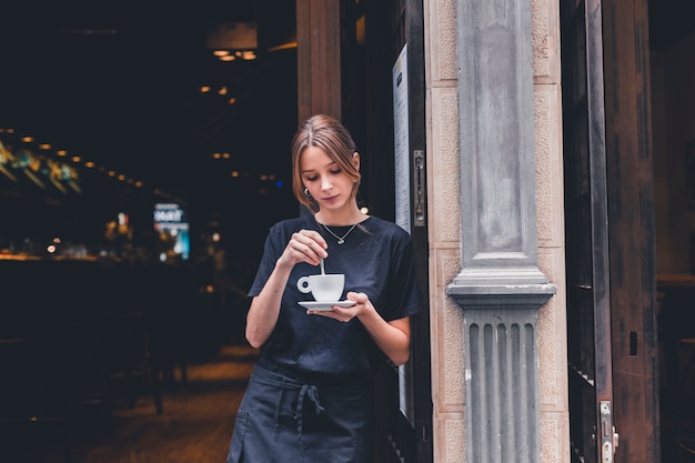 Free photo waitress stirring hot beverage