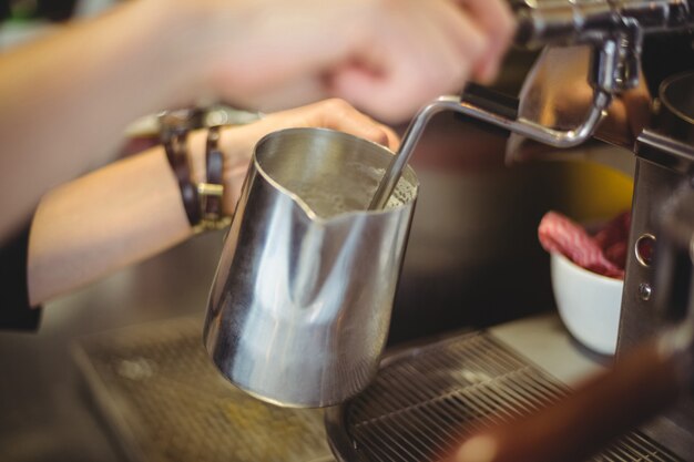 Waitress using the coffee machine