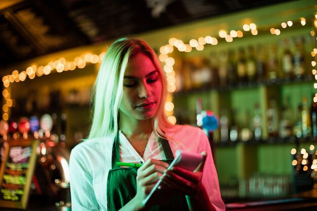 Waitress writing an order on notepad