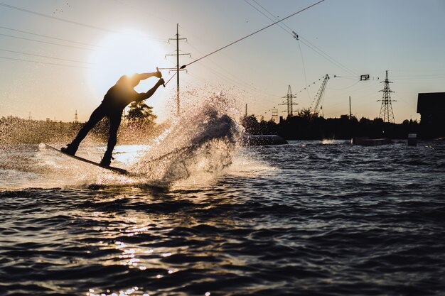 wakeboard. wakeboarding jumping at sunset