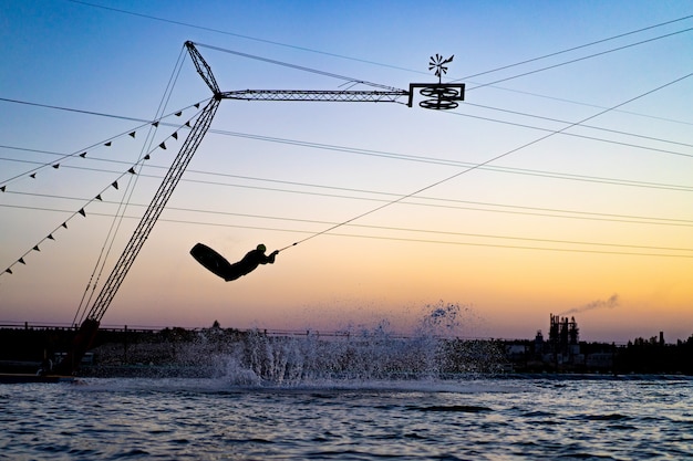 wakeboard. wakeboarding jumping at sunset