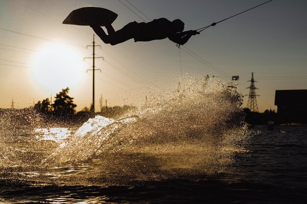 wakeboard. wakeboarding jumping at sunset