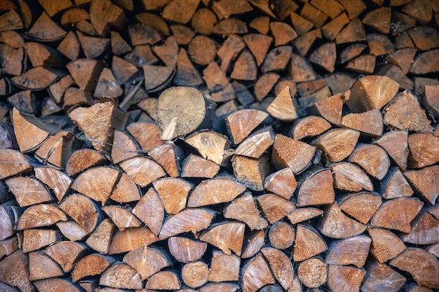 Free photo wall of stacked wooden logs as background