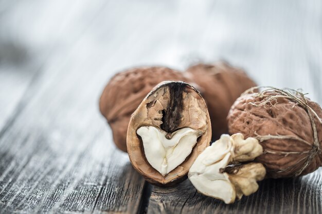 Walnut in open form on a wooden wall, close-up .