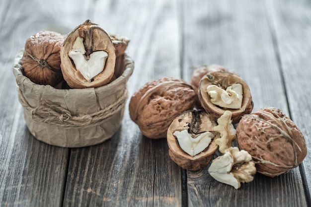 Walnut in open form on a wooden wall, close-up .