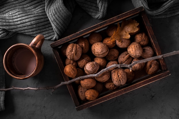 Free photo walnuts in box and hot chocolate