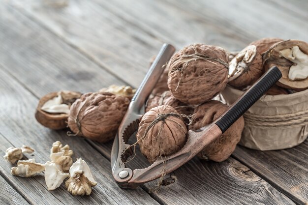 Walnuts and nutcracker on wooden table