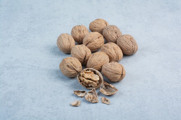 Walnuts and walnut kernels on blue background. High quality photo