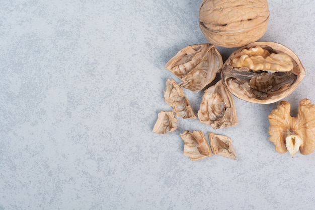 Walnuts and walnut kernels on blue background. High quality photo