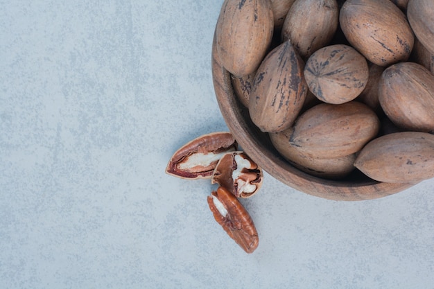 Walnuts and walnut kernels in wooden bowl. High quality photo