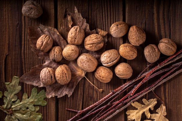 Walnuts on wooden table with leaves