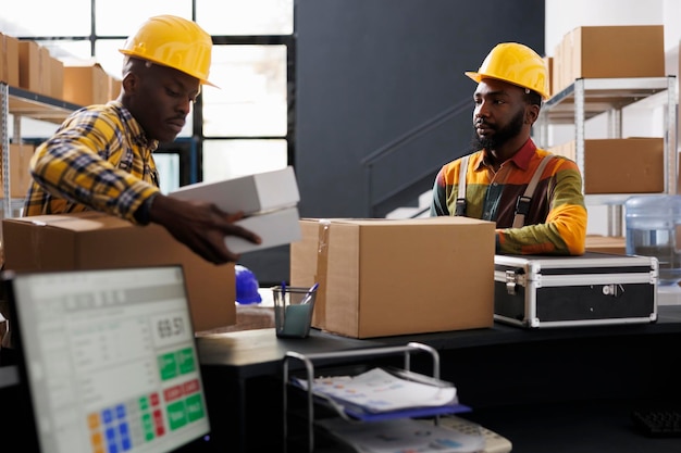 Warehouse employees putting boxes on desk ready for shipment