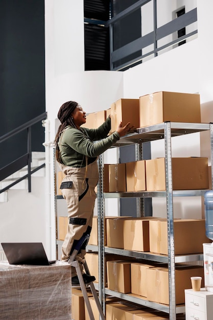 Free photo warehouse worker taking out carton boxes from shelf