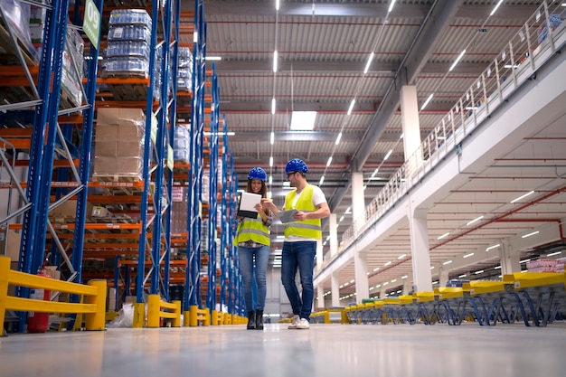 Warehouse workers working together on organizing goods distribution to the market