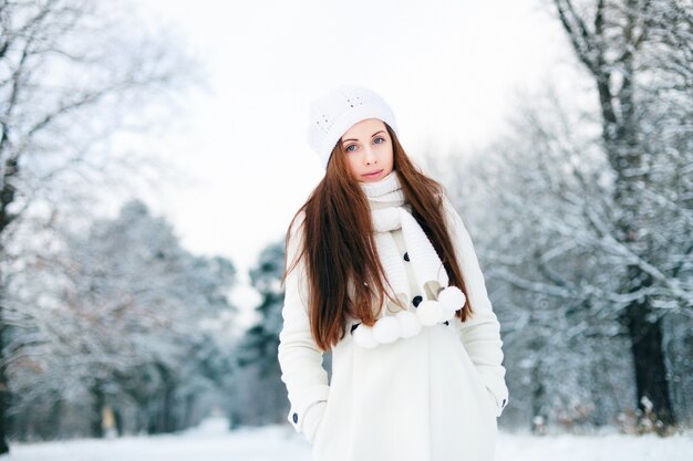 Warm woman in the snowy forest