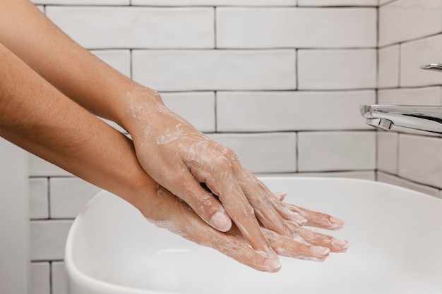 Free Photo washing hands rubbing with soap side view