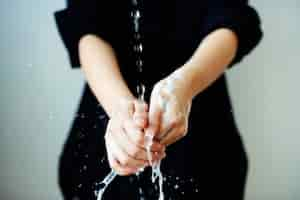 Free photo washing hands under running water to prevent infection