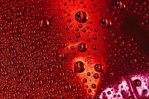 Water bubbles over the red textured background