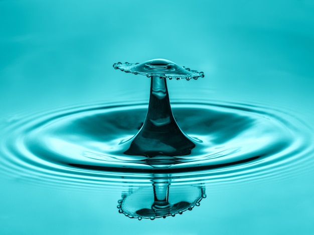 Free photo water drop collision with abstract blue effect