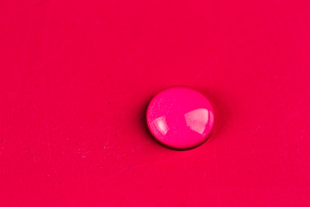 Water droplet on red background