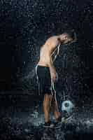 Free photo water drops around football player