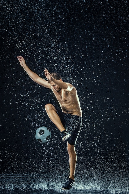 Free photo water drops around football player