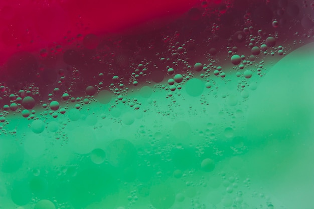 Free Photo water drops over the green and red painted background