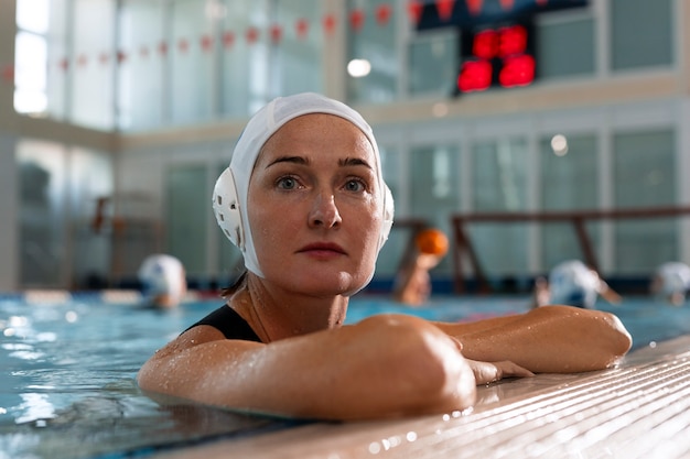 Free photo water polo player at the pool with swimming equipment