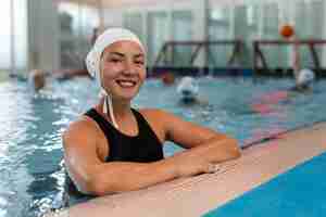 Free photo water polo player at the pool with swimming equipment